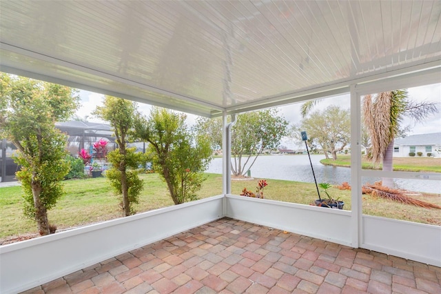 unfurnished sunroom featuring a water view