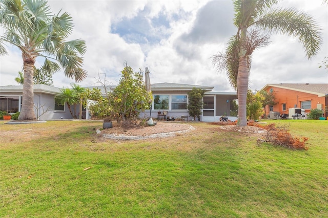 view of front of house featuring a front lawn and stucco siding