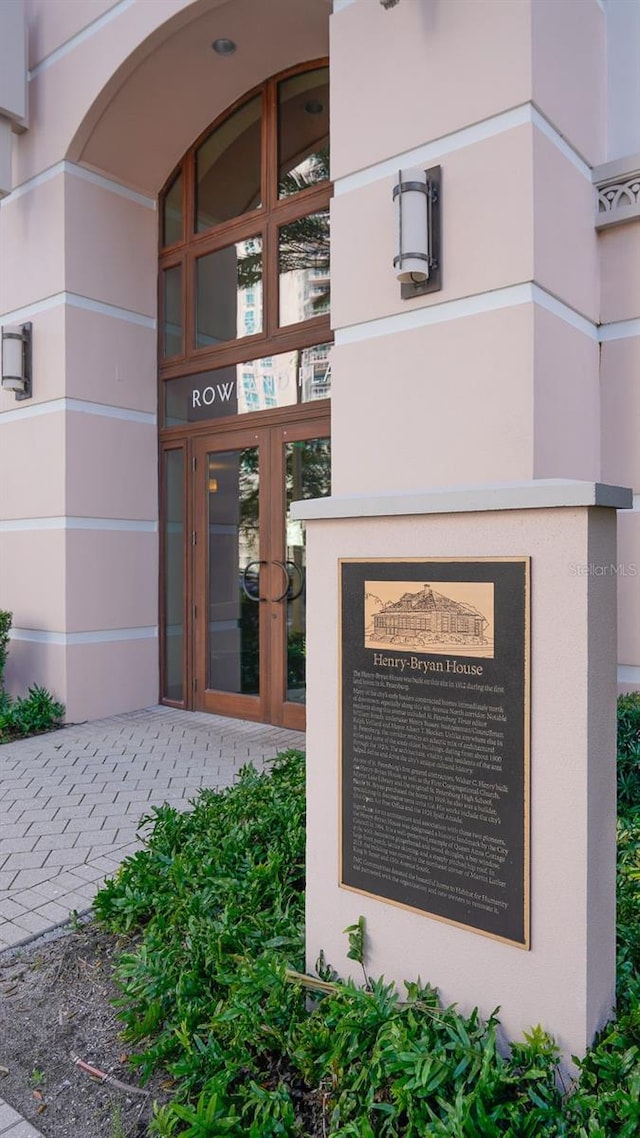 entrance to property featuring french doors and stucco siding