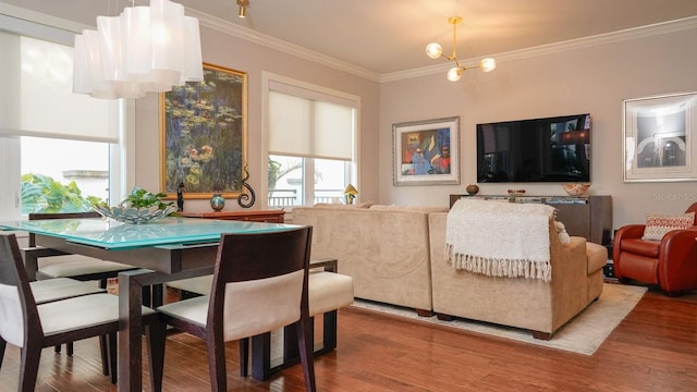 dining area featuring wood finished floors and crown molding