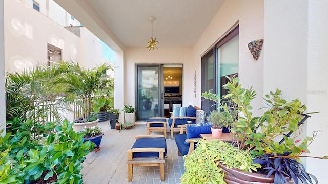 doorway to property with a patio, an outdoor hangout area, and stucco siding