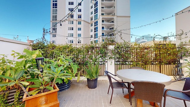 balcony featuring outdoor dining space and a patio area