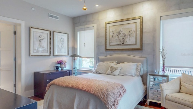 bedroom with wood finished floors and visible vents