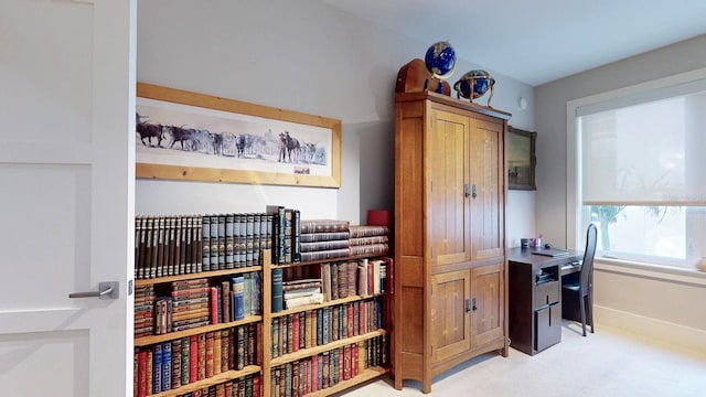 office featuring baseboards and light colored carpet