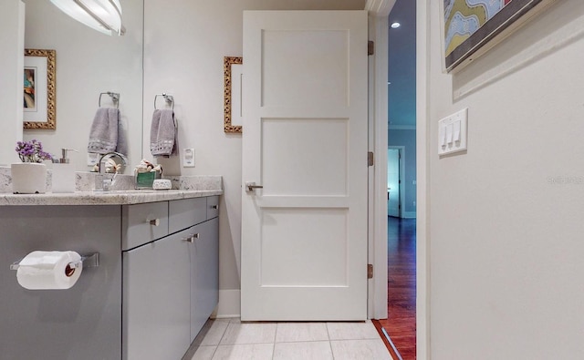 bathroom with tile patterned flooring, vanity, and baseboards