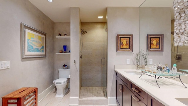 full bath featuring double vanity, toilet, a stall shower, a sink, and baseboards