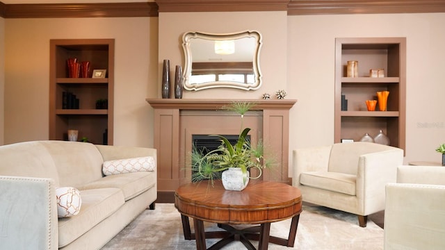 living room featuring a fireplace, built in features, and crown molding