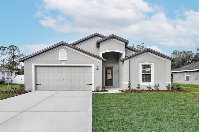 single story home featuring a garage, driveway, a front yard, and stucco siding