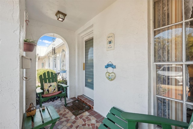 view of exterior entry featuring stucco siding