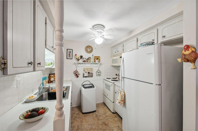 kitchen featuring white appliances, tasteful backsplash, light countertops, and a sink