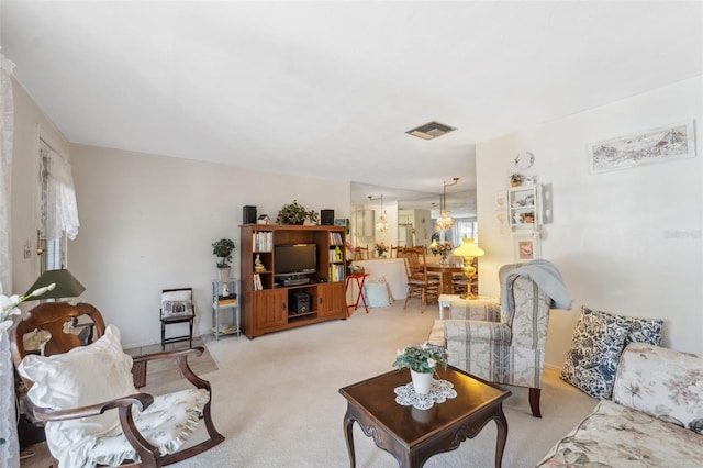 living area featuring light carpet and visible vents