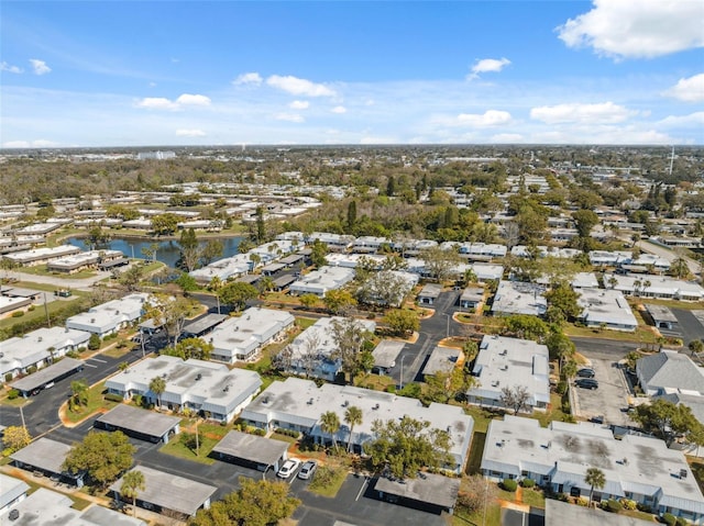 drone / aerial view featuring a residential view and a water view