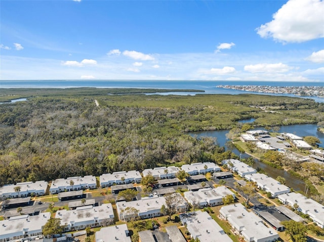 aerial view with a forest view, a water view, and a residential view