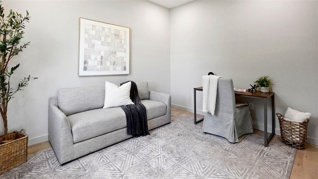 sitting room featuring baseboards and light wood-style floors