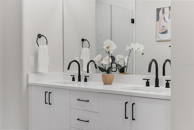 full bath with double vanity and a sink