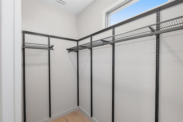 walk in closet featuring light wood-style flooring and visible vents