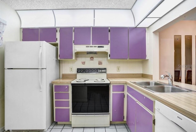 kitchen with light countertops, white appliances, a sink, and under cabinet range hood