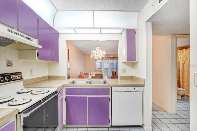 kitchen with white appliances, light countertops, under cabinet range hood, pendant lighting, and a sink