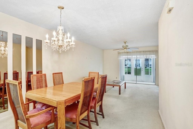 dining space with light carpet, baseboards, a textured ceiling, and ceiling fan with notable chandelier