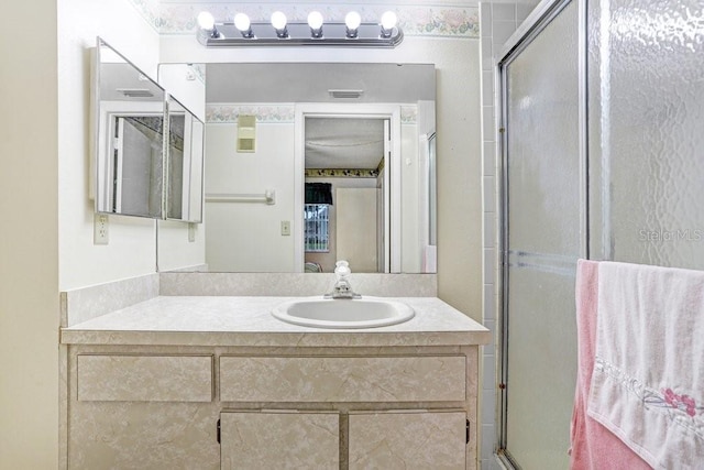 full bath featuring visible vents, vanity, and an enclosed shower