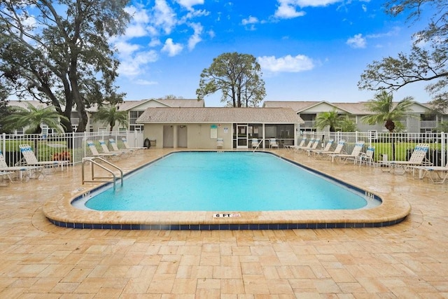 community pool featuring a patio area and fence