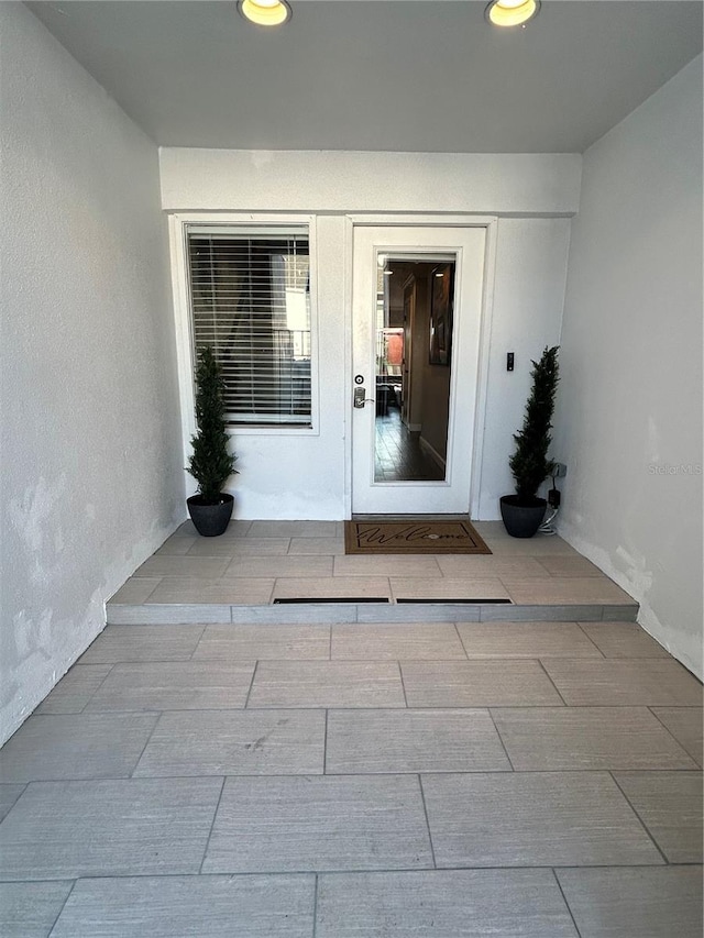 entrance to property featuring stucco siding