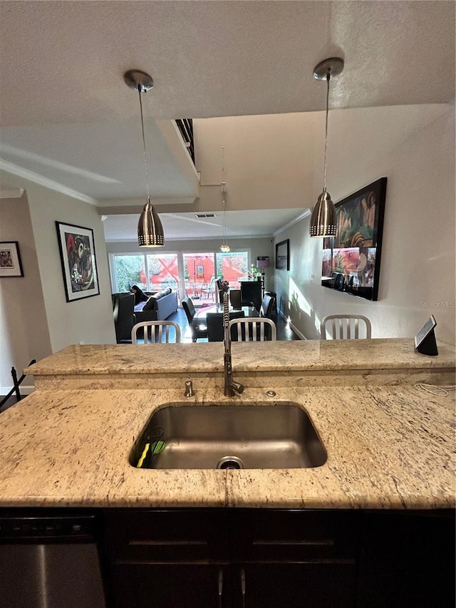 kitchen featuring decorative light fixtures, a sink, crown molding, light stone countertops, and dishwasher