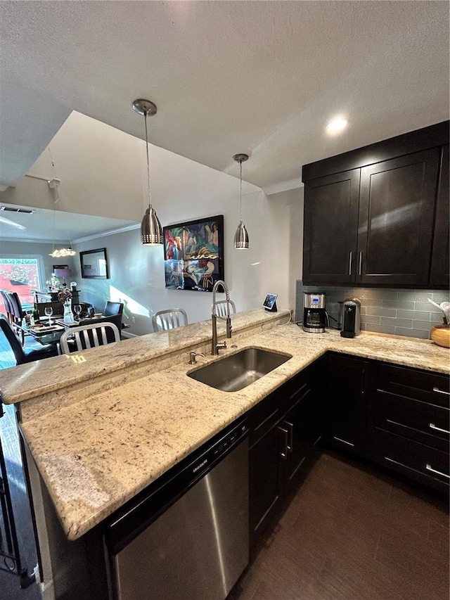 kitchen with light stone countertops, dishwasher, decorative backsplash, a peninsula, and a sink