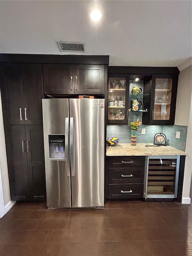 bar with wine cooler, visible vents, stainless steel fridge, and tasteful backsplash