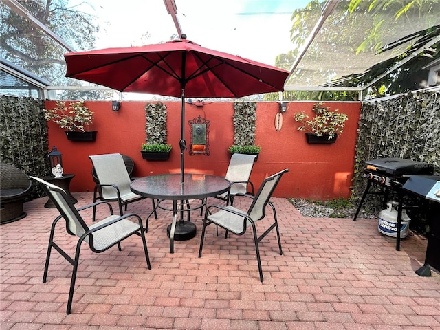 view of patio / terrace featuring a lanai and outdoor dining area