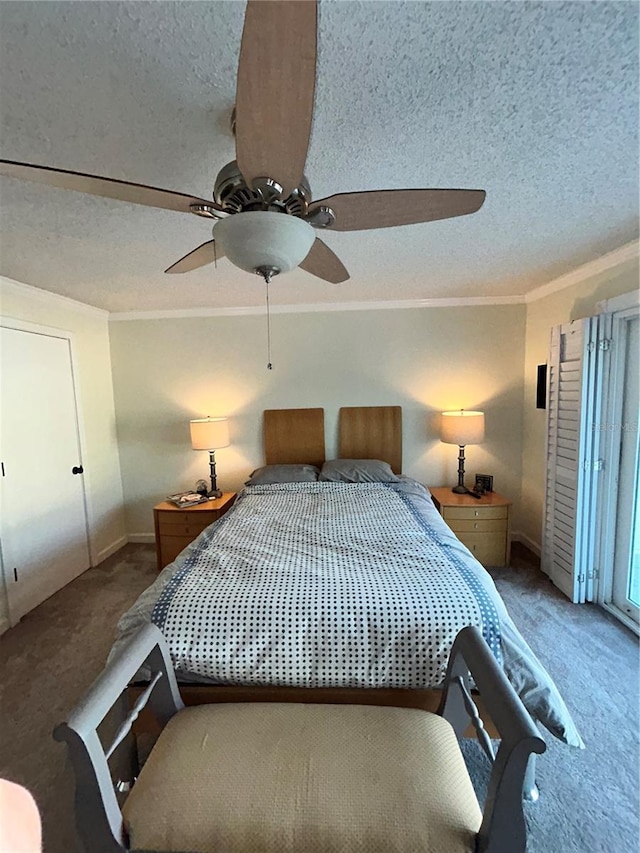 carpeted bedroom featuring a textured ceiling, ceiling fan, and ornamental molding