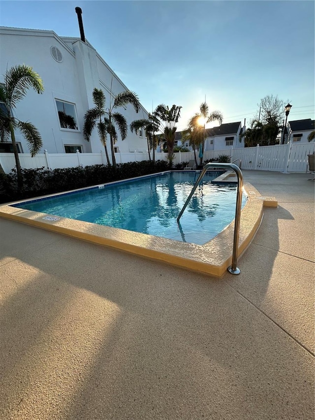 pool featuring a patio and fence