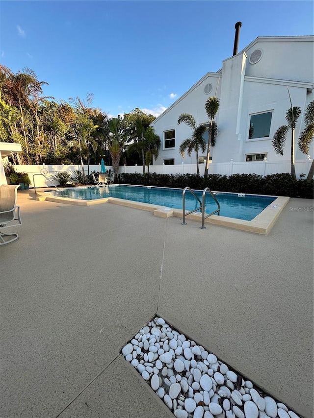 view of pool featuring a fenced in pool, a patio, and fence