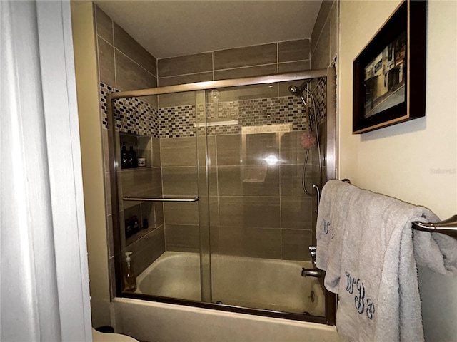 bathroom featuring shower / bath combination with glass door