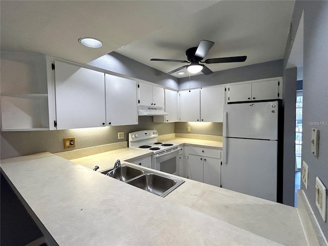 kitchen with light countertops, white cabinetry, a sink, white appliances, and under cabinet range hood