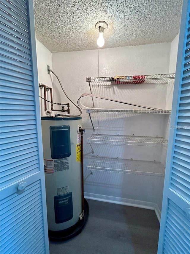 utility room featuring electric water heater