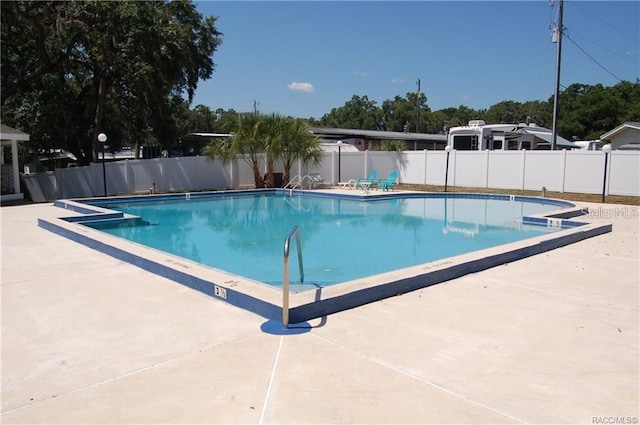 pool featuring a patio area and fence