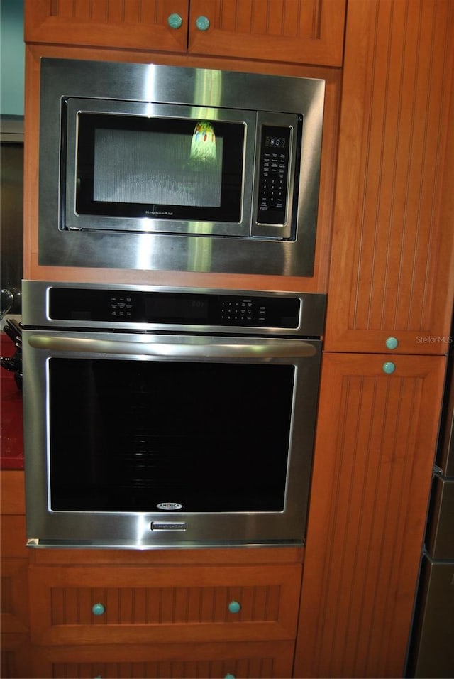 room details featuring stainless steel appliances and brown cabinets