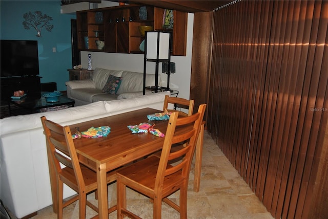 dining space with stone finish floor