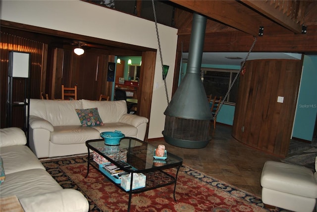 living room with wood walls and a wood stove