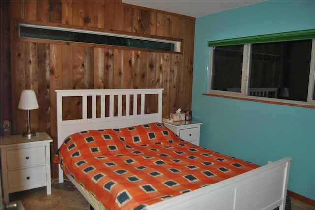 bedroom featuring wood walls