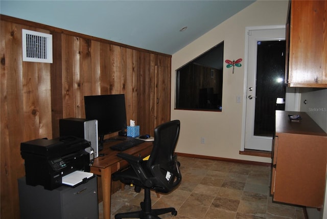 home office featuring baseboards, visible vents, and wooden walls