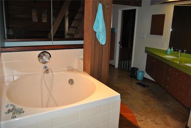 full bath featuring a garden tub and vanity