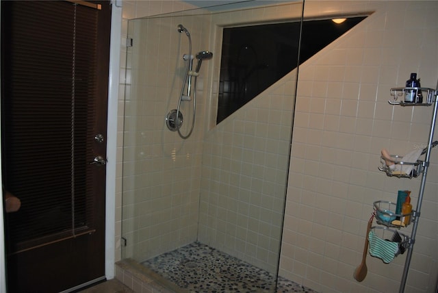 full bath with a tile shower