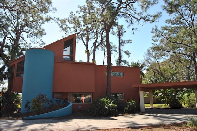 view of side of home with concrete driveway