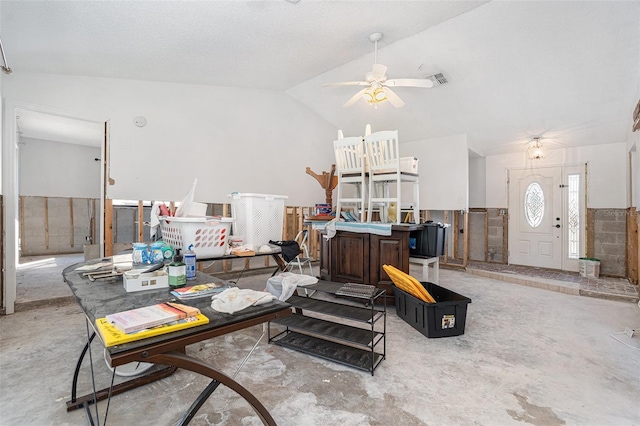 living room with lofted ceiling, concrete floors, wainscoting, and a ceiling fan