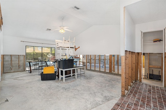 living area featuring lofted ceiling, ceiling fan, and visible vents