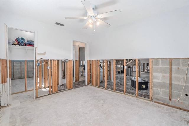 empty room featuring ceiling fan, concrete floors, and visible vents