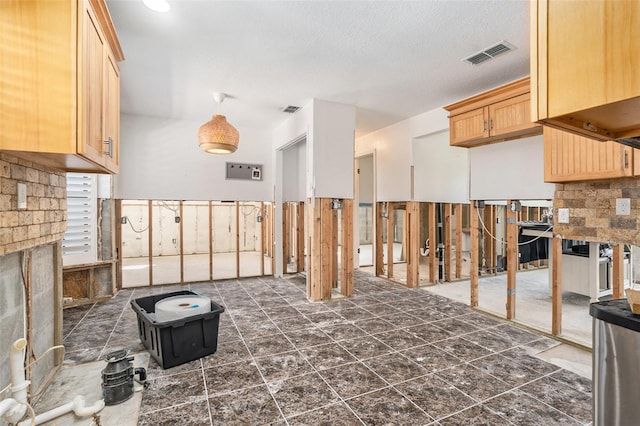 miscellaneous room with visible vents and a textured ceiling