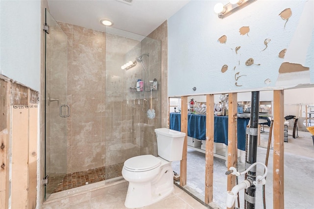 full bathroom with a shower stall and toilet